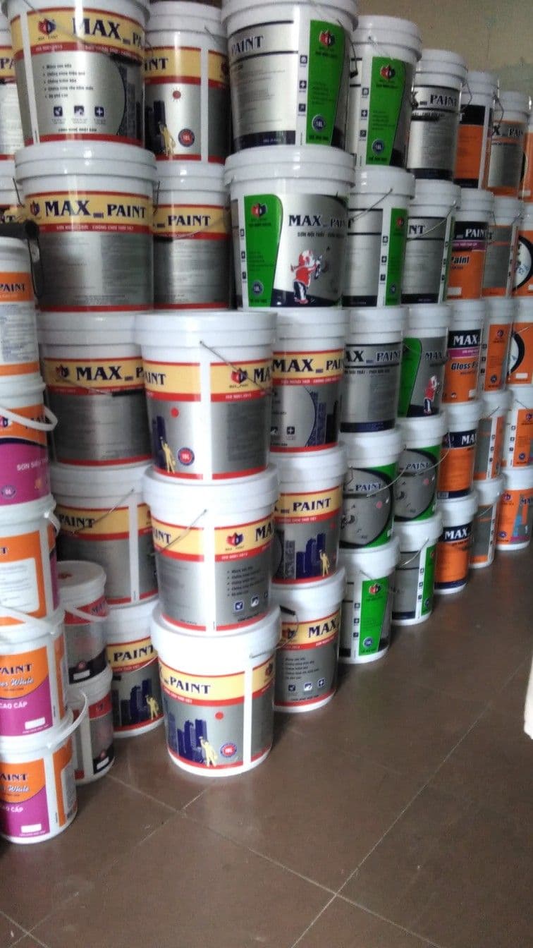 Columns of sealed paint and coatings pails stacked in a distribution store