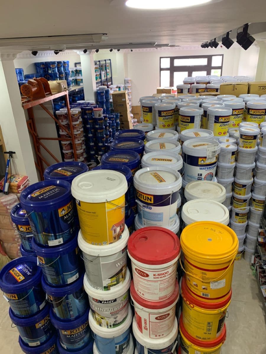 Shelved and palletised coatings stock filling a supply warehouse floor